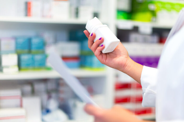 Woman customer in the pharmacy taking a medicine box