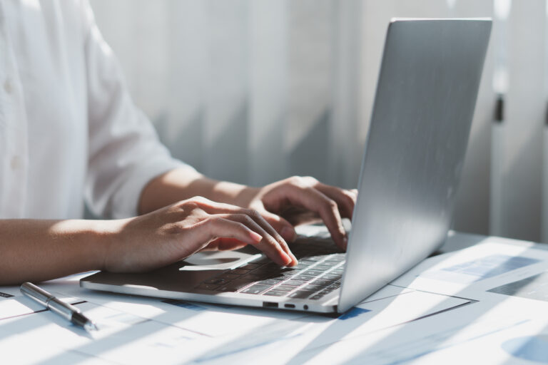 Close up of businessman or accountant working on laptop computer